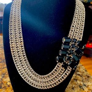 Silver tone necklace with embellishments of black gems
